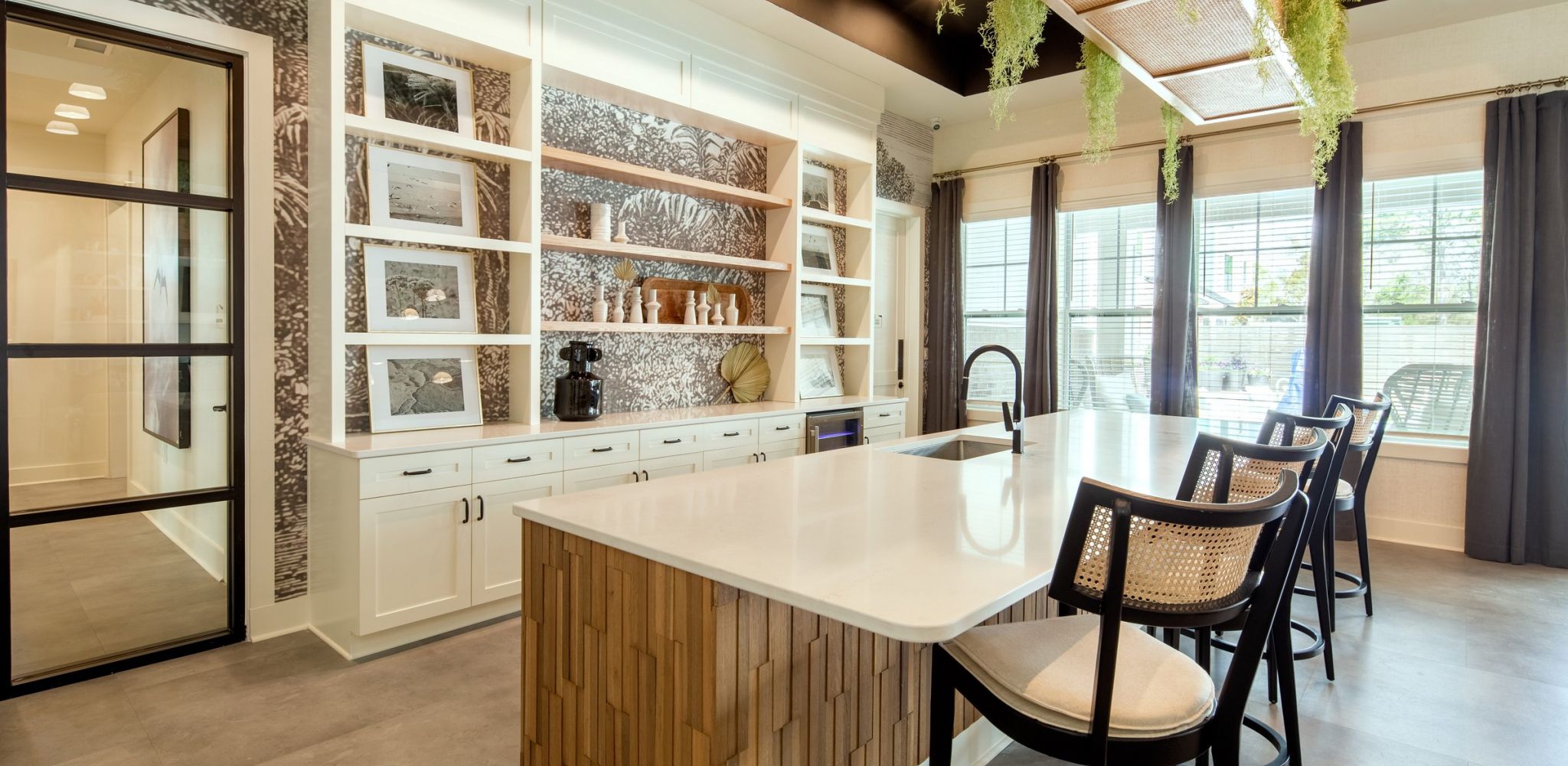 Hawthorne at Oleander resident amenity area with large island with chairs, stainless steel appliances, and a large sink